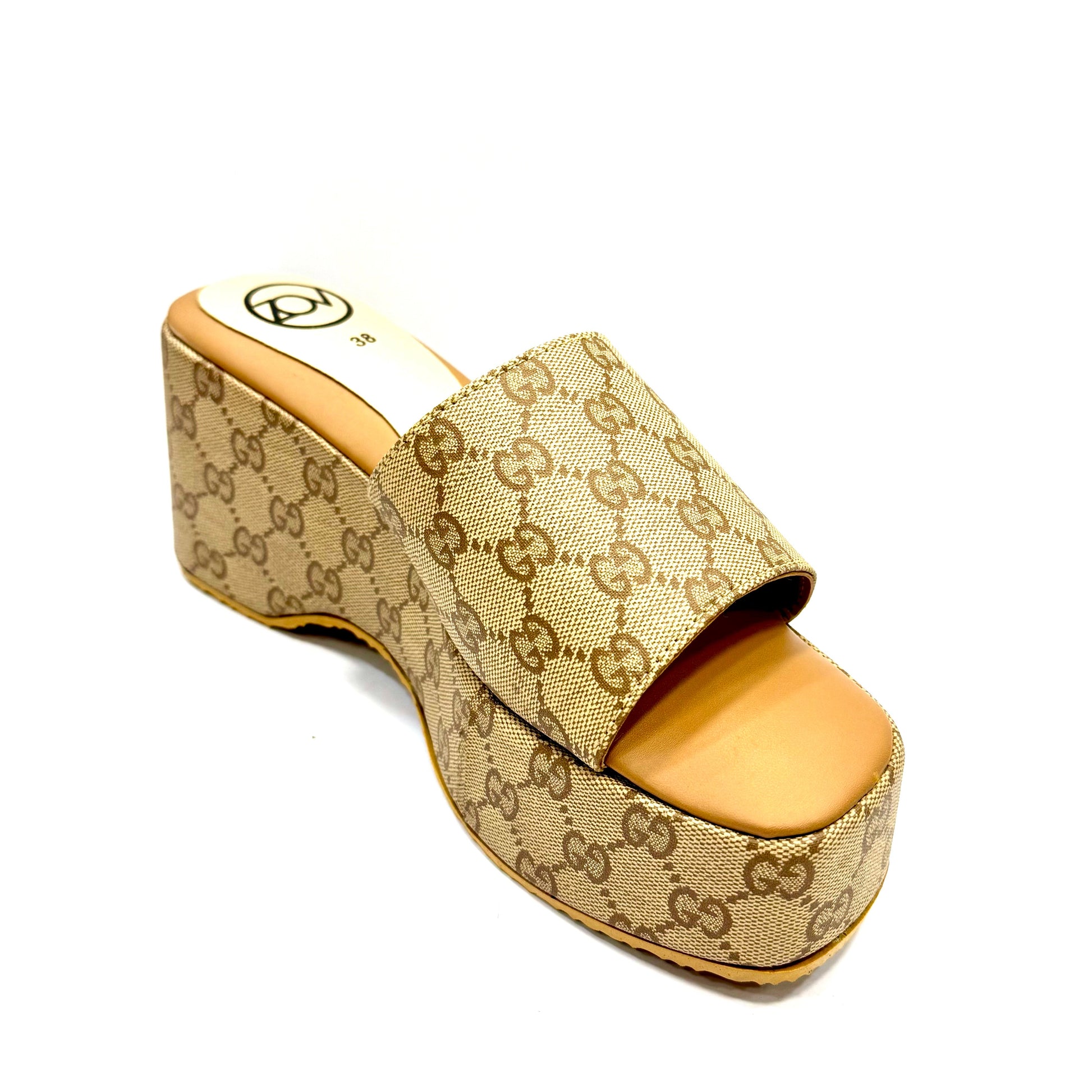 Beige platform sandal with Gucci logo on a white background