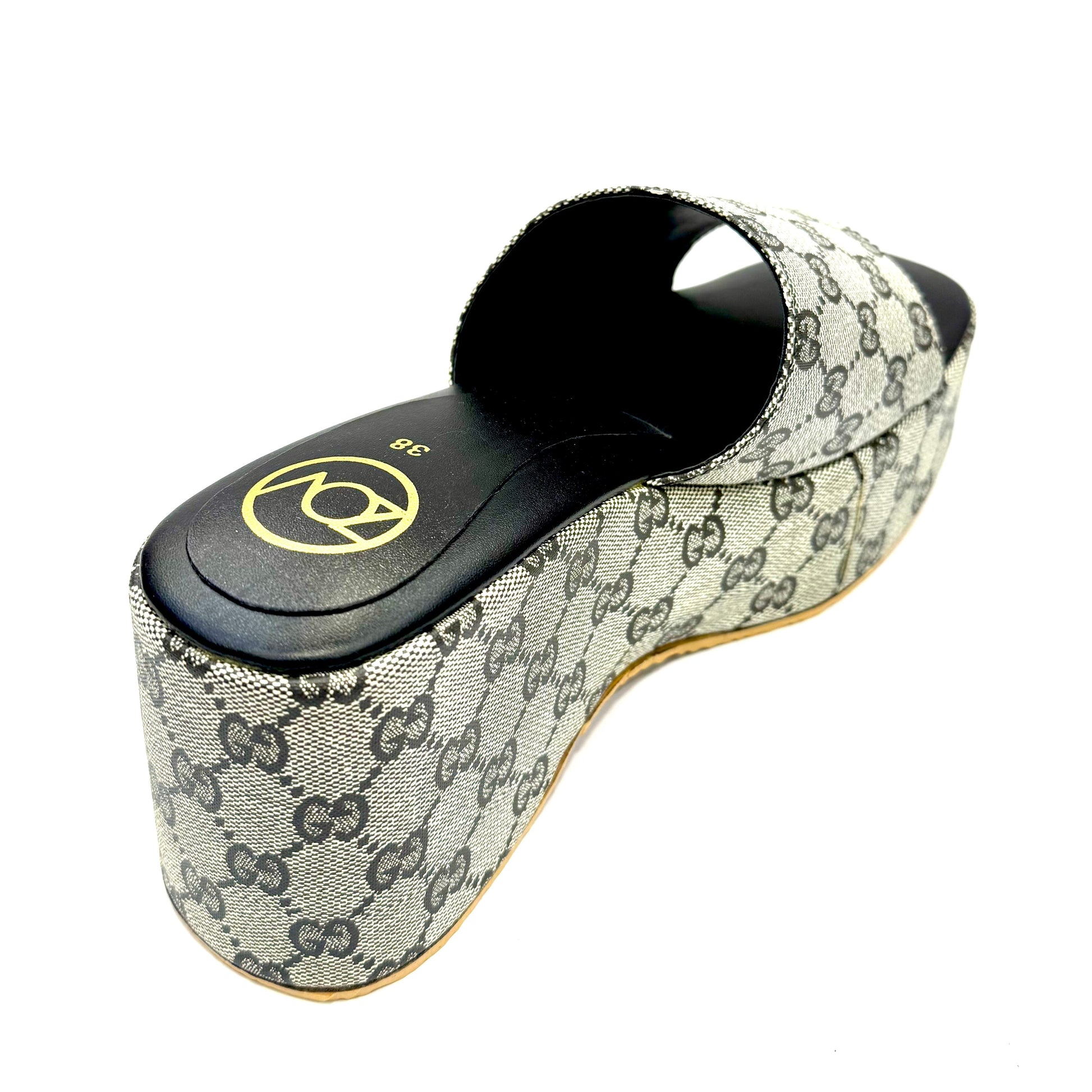 Black sandal with Gucci logo on a white background