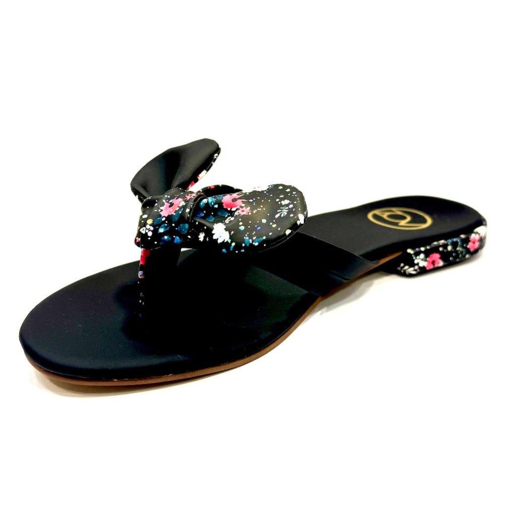 Black sandal with floral design on a white background