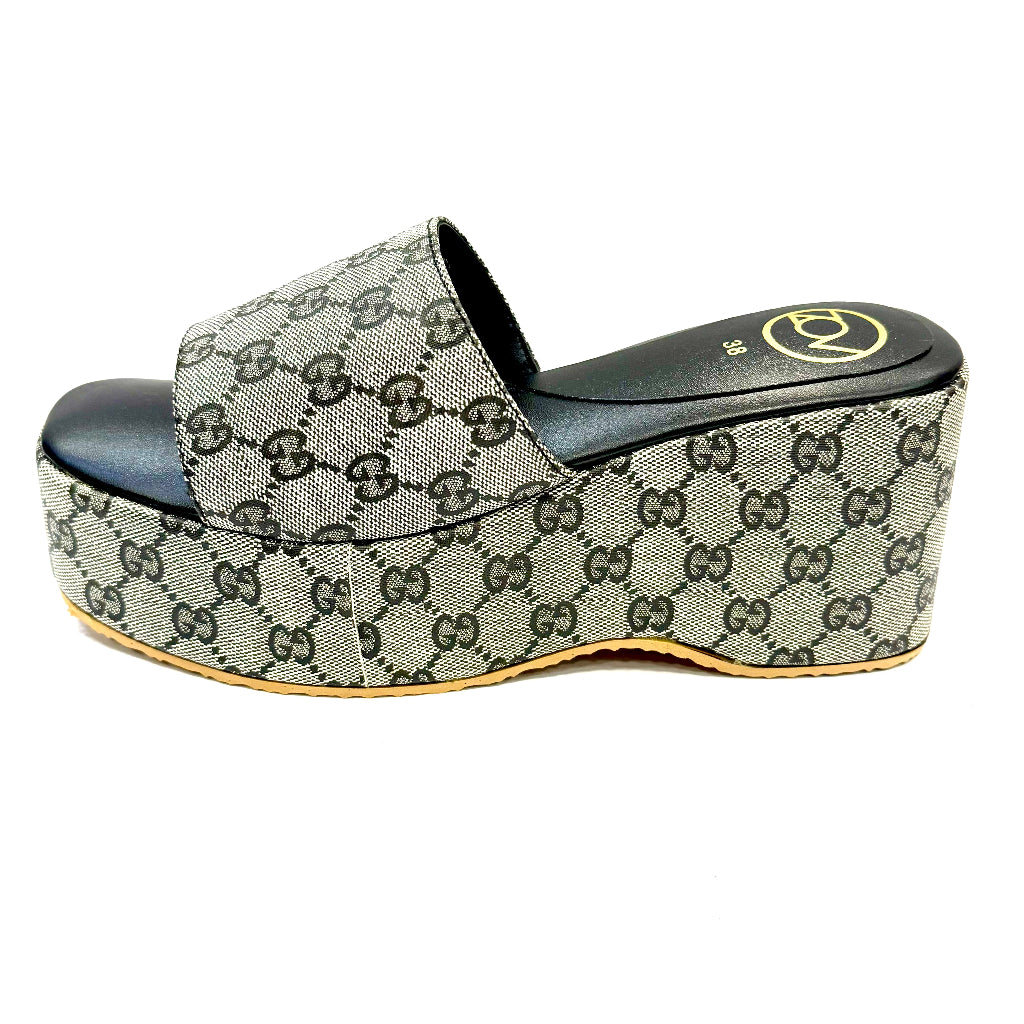 Platform sandal with Gucci logo pattern on a white background