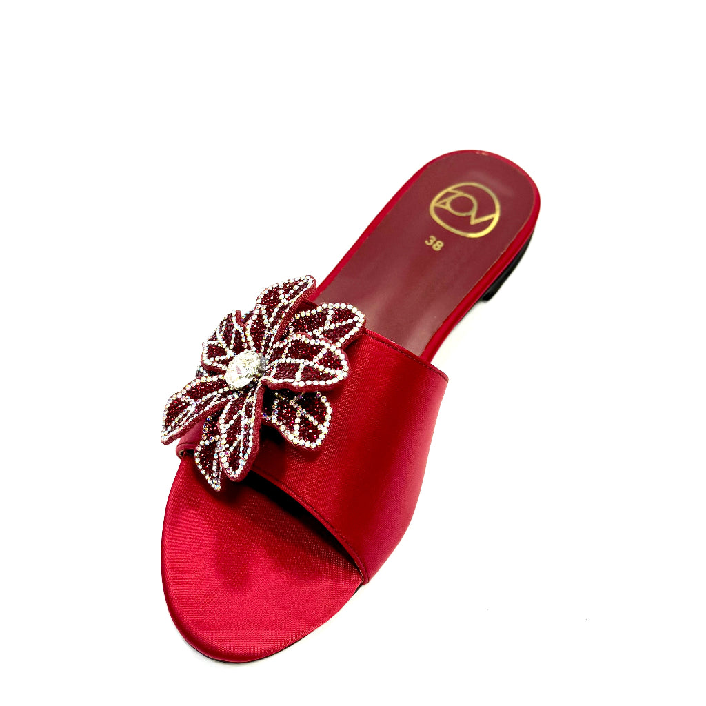 Red sandal with a decorative flower on a white background