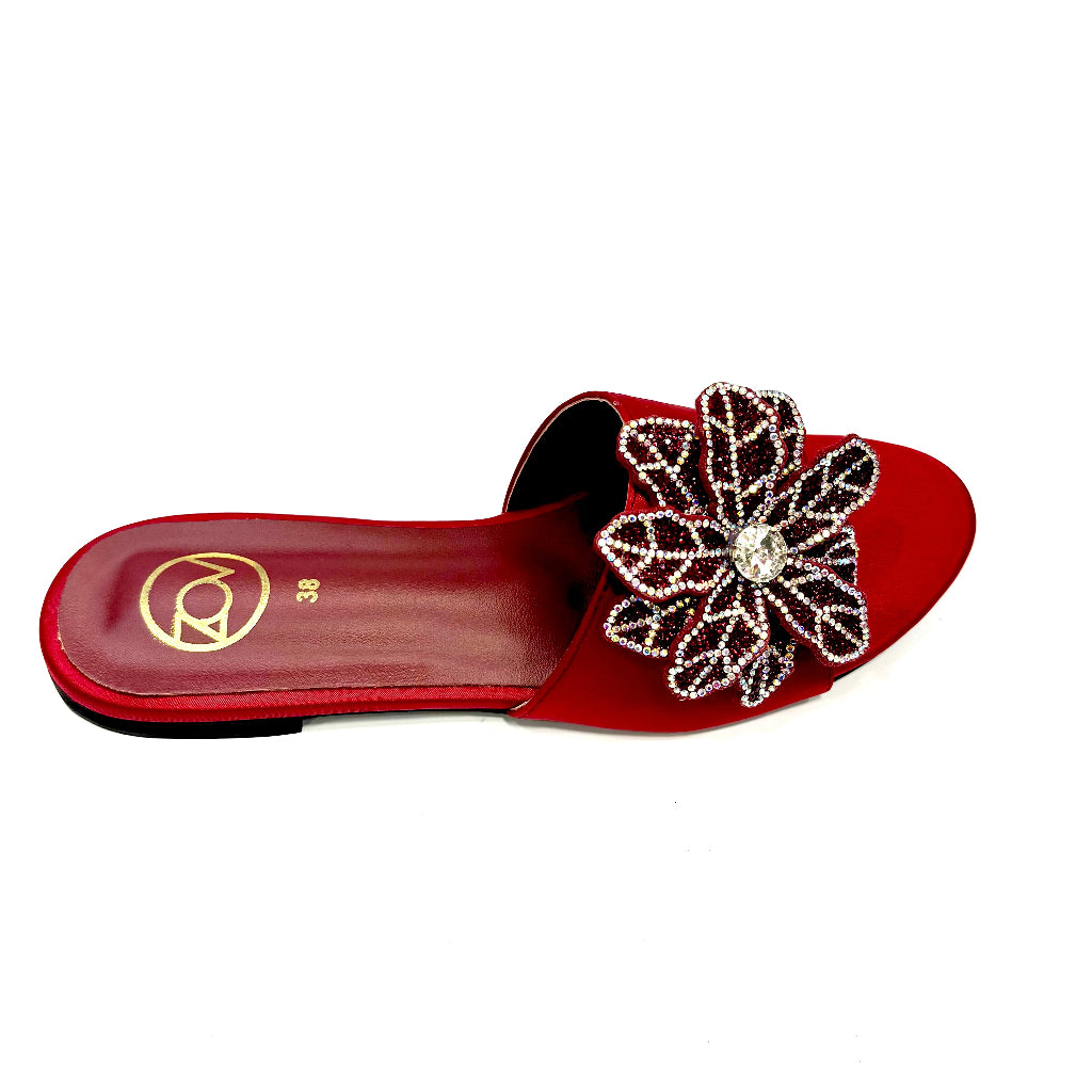 Red sandal with a decorative flower on a white background